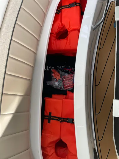  Yacht Photos Pics Storage compartment on a 2006 Four Winns 350 boat with orange life jackets.