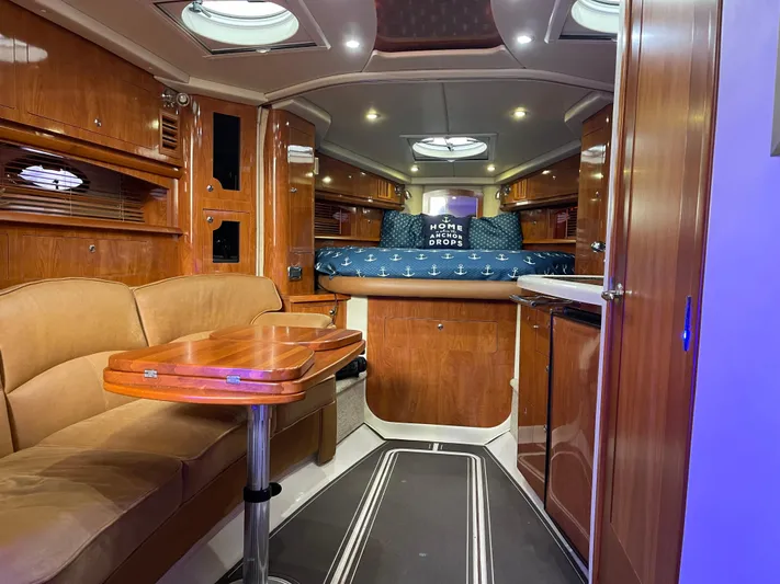  Yacht Photos Pics Luxurious interior of a 2006 Four Winns 350 yacht with wood finishes and cozy seating.