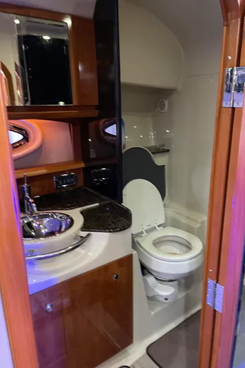  Yacht Photos Pics 2006 Four Winns 350 yacht bathroom with modern fixtures and wood accents.
