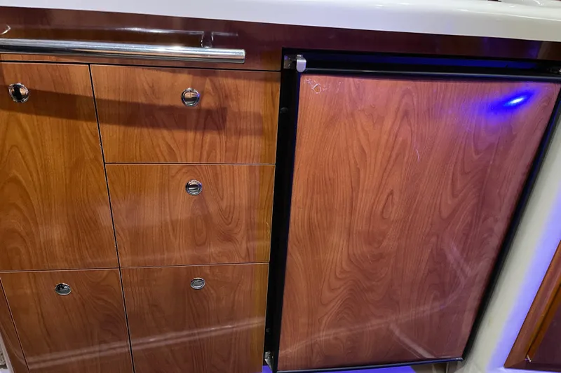  Yacht Photos Pics Wooden cabinetry and mini fridge in 2006 Four Winns 350 boat interior.