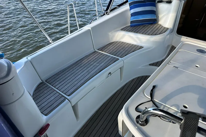 Tbd Yacht Photos Pics Cockpit of 2008 Jeanneau Sun Odyssey 42 DS sailboat with cushioned seating and striped pillow.