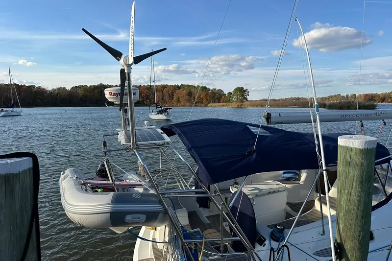 Tbd Yacht Photos Pics 2008 Jeanneau Sun Odyssey 42 DS sailboat docked with blue canopy and wind turbine.