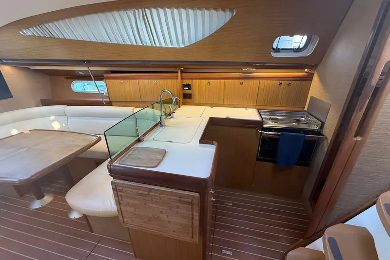 Tbd Yacht Photos Pics Interior of 2008 Jeanneau Sun Odyssey 42 DS yacht, featuring kitchen and dining area.