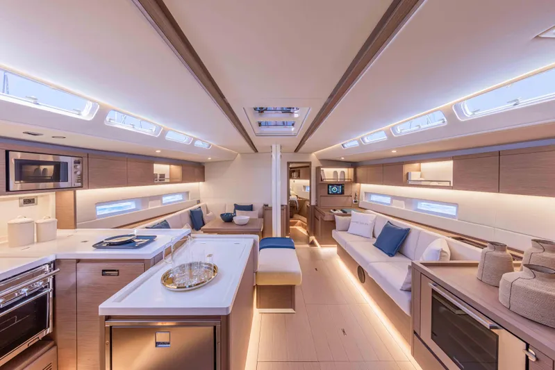 Yacht Photos Pics Luxurious interior of 2026 Grand Soleil 52 Performance yacht, featuring modern kitchen and seating area.