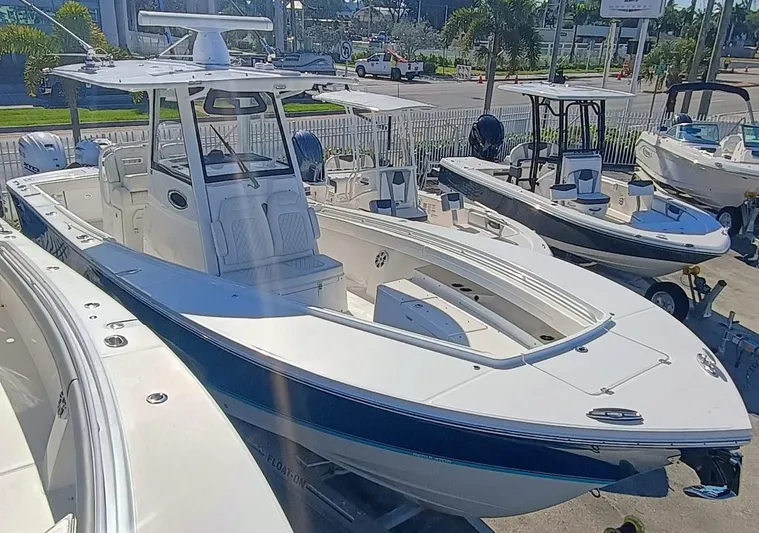  Yacht Photos Pics 2024 Regulator 31 boat displayed in a marina, showcasing sleek design and modern features.