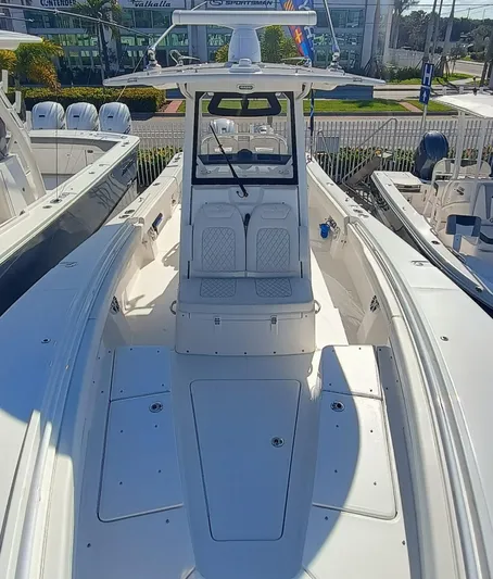  Yacht Photos Pics 2024 Regulator 31 boat with spacious deck and seating, displayed outdoors.
