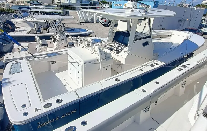  Yacht Photos Pics 2024 Regulator 31 boat with sleek design and modern features, docked at a marina.