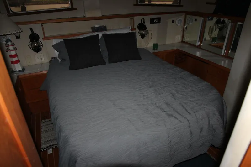 Aurora II Yacht Photos Pics Cozy bedroom interior of 1989 Chris-Craft 480 Catalina yacht with gray bedding.