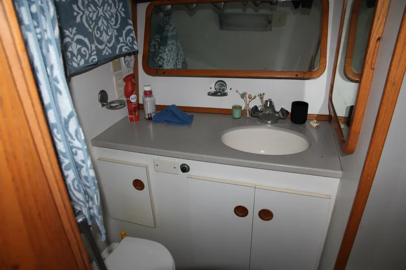 Aurora II Yacht Photos Pics Bathroom interior of 1989 Chris-Craft 480 Catalina yacht with sink and mirror.
