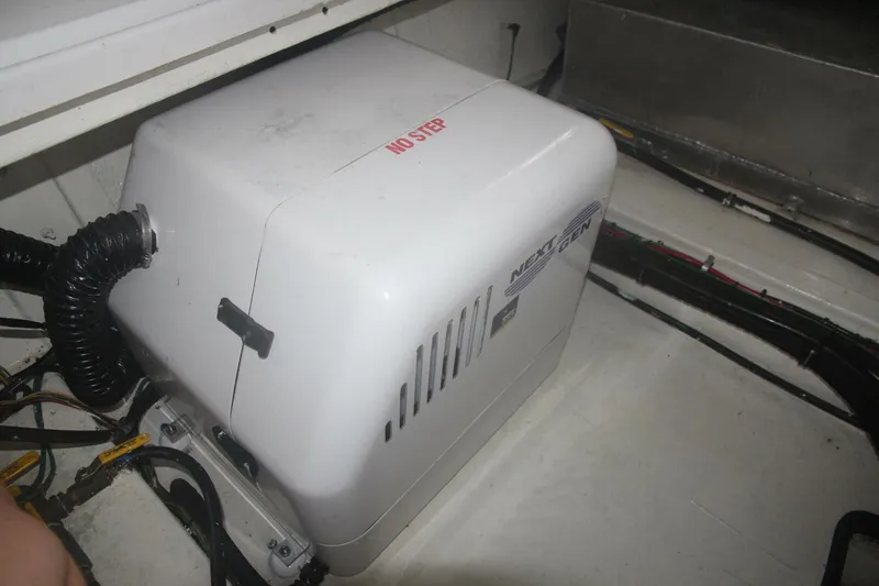 Aurora II Yacht Photos Pics 1989 Chris-Craft 480 Catalina engine compartment with a generator labeled "NO STEP."