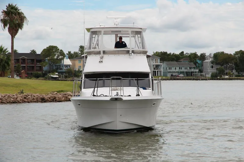 Aurora II Yacht Photos Pics 1989 Chris-Craft 480 Catalina yacht cruising on a calm waterway.