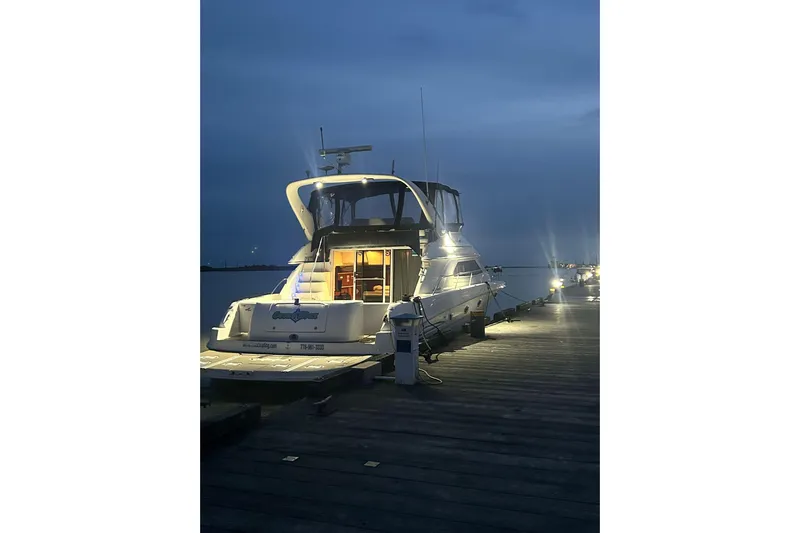 Oceanmax Yacht Photos Pics 2000 Sea Ray 450 Express Bridge yacht docked at night, illuminated and ready for adventure.