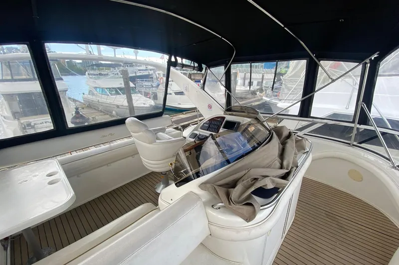 Oceanmax Yacht Photos Pics 2000 Sea Ray 450 Express Bridge yacht interior with helm and seating area.