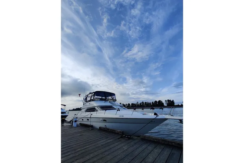 Oceanmax Yacht Photos Pics 2000 Sea Ray 450 Express Bridge yacht docked under a vibrant blue sky.