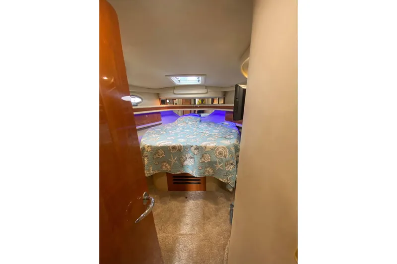 Oceanmax Yacht Photos Pics Interior cabin of 2000 Sea Ray 450 Express Bridge with patterned bedspread.