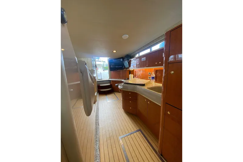 Oceanmax Yacht Photos Pics Interior of 2000 Sea Ray 450 Express Bridge yacht with wooden cabinetry and modern amenities.