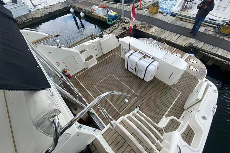 Oceanmax Yacht Photos Pics 2000 Sea Ray 450 Express Bridge yacht with spacious deck and dockside view.