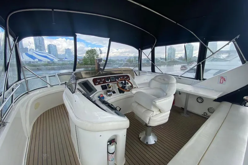 Oceanmax Yacht Photos Pics Interior view of 2000 Sea Ray 450 Express Bridge yacht with helm and seating.