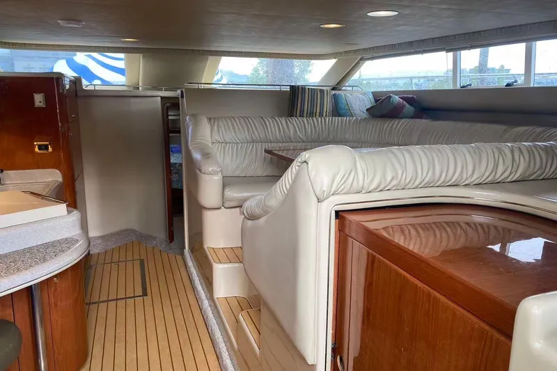 Oceanmax Yacht Photos Pics Luxurious interior of 2000 Sea Ray 450 Express Bridge yacht with plush seating and wood accents.