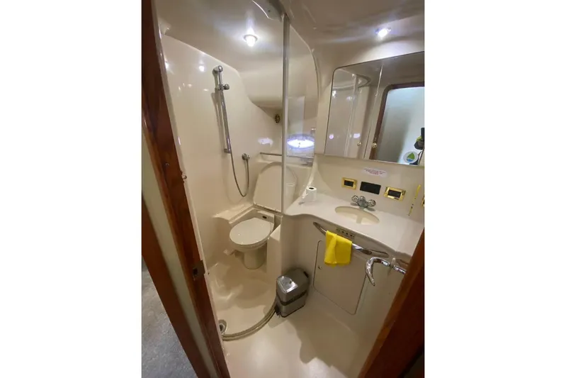 Oceanmax Yacht Photos Pics Bathroom interior of 2000 Sea Ray 450 Express Bridge yacht, featuring shower and sink.