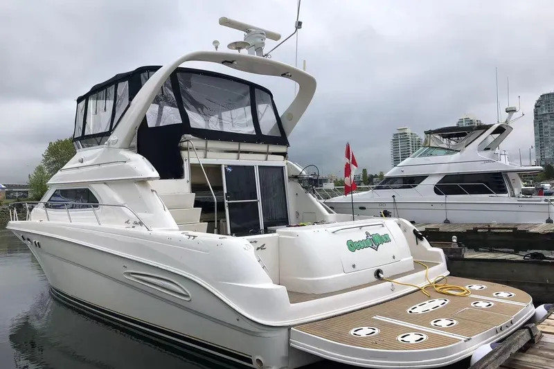 Oceanmax Yacht Photos Pics 2000 Sea Ray 450 Express Bridge yacht docked at marina, overcast sky.