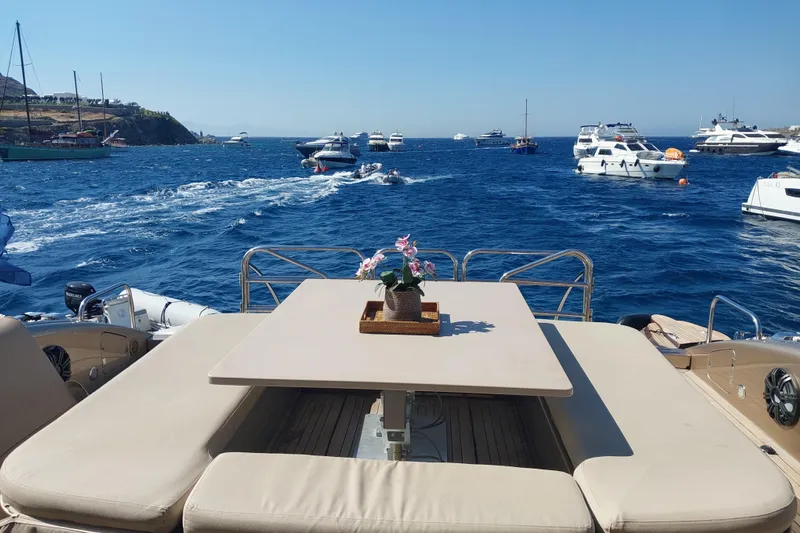 Yacht Photos Pics Luxurious Arno Leopard 24 yacht deck with table, flowers, and scenic ocean view, 2006 model.