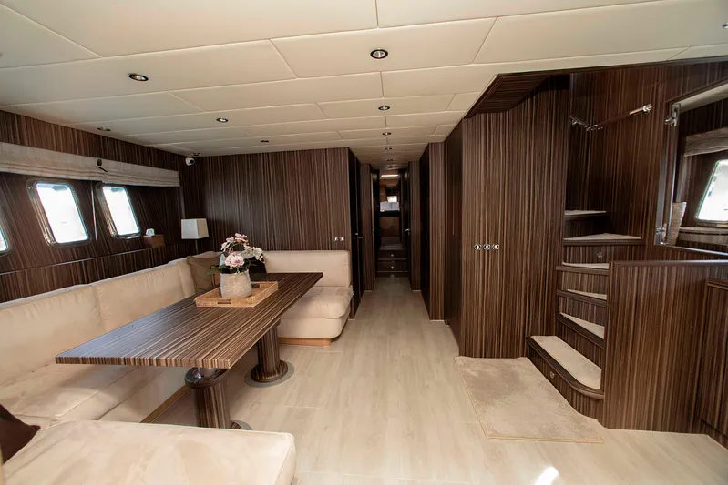  Yacht Photos Pics Luxurious interior of 2006 Arno Leopard 24 yacht with elegant wood paneling and plush seating.