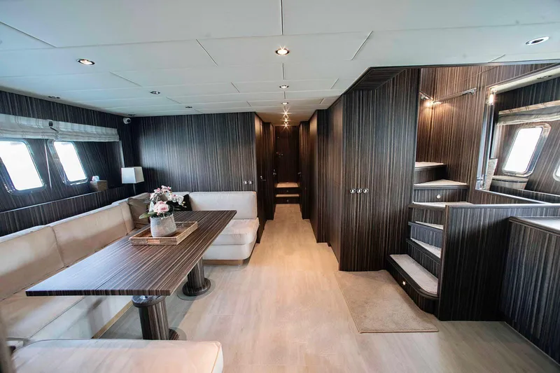  Yacht Photos Pics Luxurious interior of 2006 Arno Leopard 24 yacht with elegant wood paneling and plush seating.