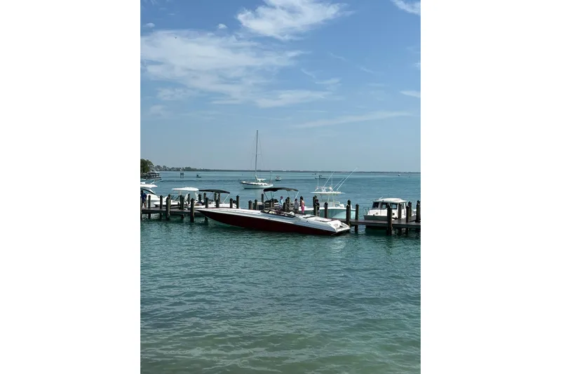  Yacht Photos Pics 2007 Fountain 42 Lightning boat docked at a marina on a sunny day.