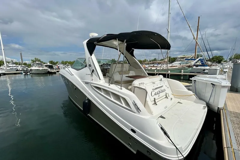  Yacht Photos Pics 2009 Sea Ray 310 Sundancer docked at marina under cloudy sky.
