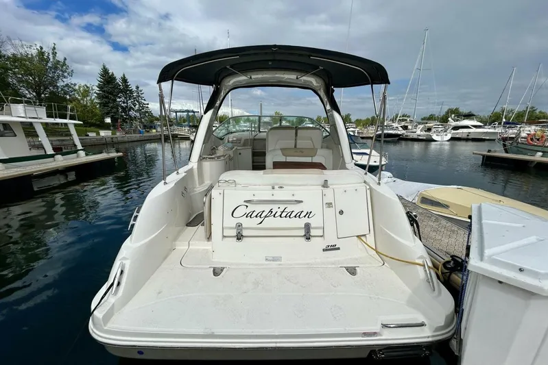  Yacht Photos Pics 2009 Sea Ray 310 Sundancer docked at marina, rear view with canopy and seating.