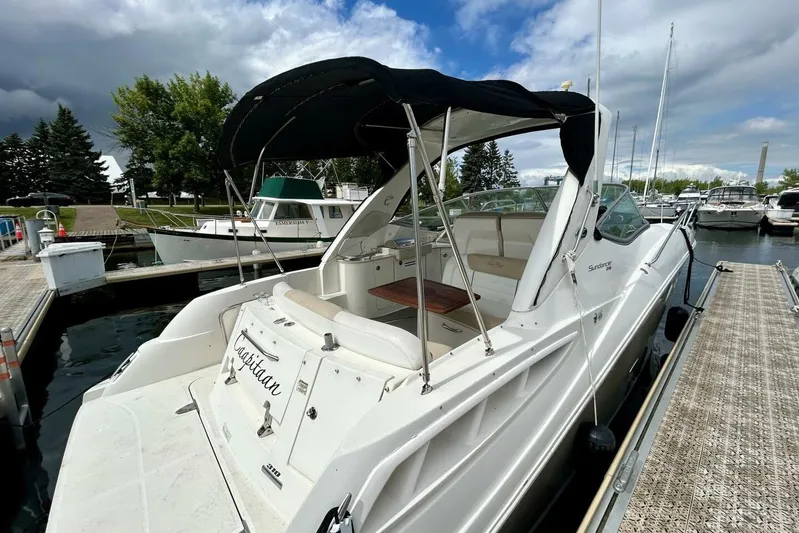  Yacht Photos Pics 2009 Sea Ray 310 Sundancer docked at marina under cloudy sky.