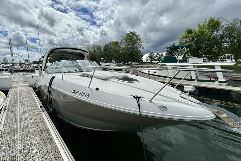  Yacht Photos Pics 2009 Sea Ray 310 Sundancer docked at marina under cloudy sky.