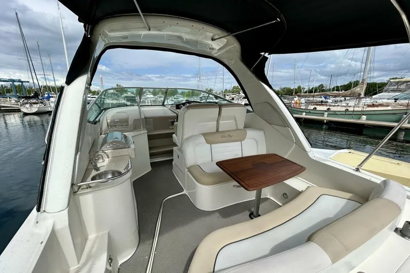  Yacht Photos Pics 2009 Sea Ray 310 Sundancer interior with seating and table, docked at marina.