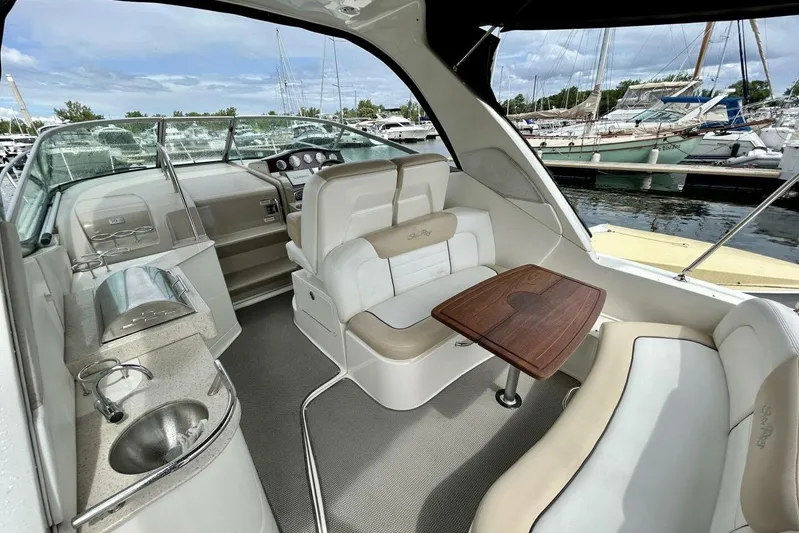  Yacht Photos Pics 2009 Sea Ray 310 Sundancer interior with seating, table, and helm at marina.