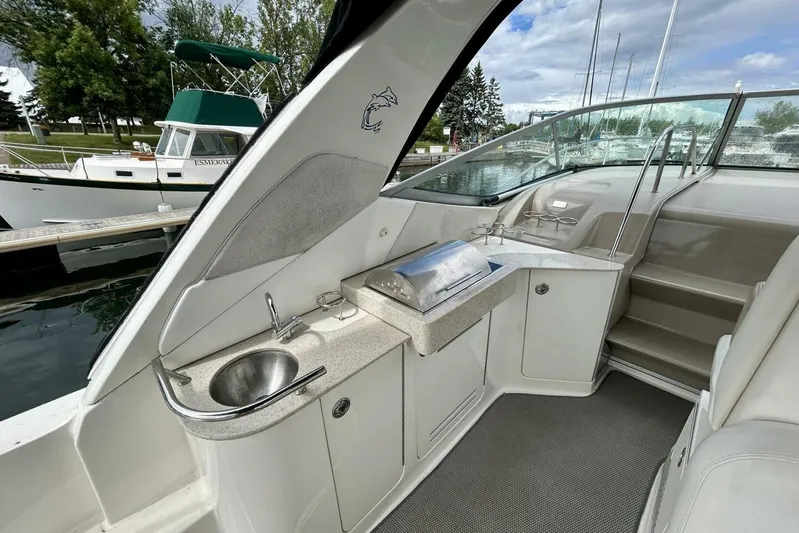  Yacht Photos Pics 2009 Sea Ray 310 Sundancer boat interior with sink and grill, docked at marina.