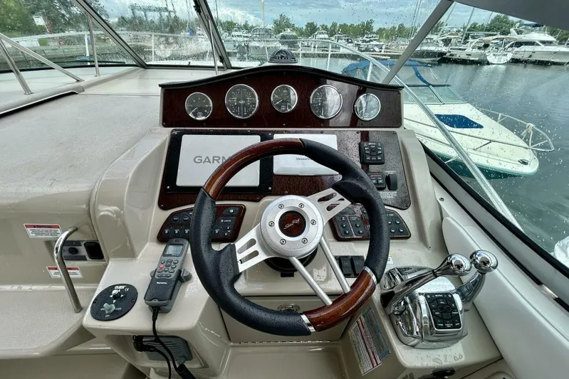  Yacht Photos Pics 2009 Sea Ray 310 Sundancer helm with Garmin navigation, steering wheel, and control panel.