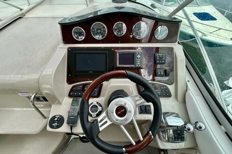  Yacht Photos Pics 2009 Sea Ray 310 Sundancer helm with gauges, steering wheel, and navigation controls.