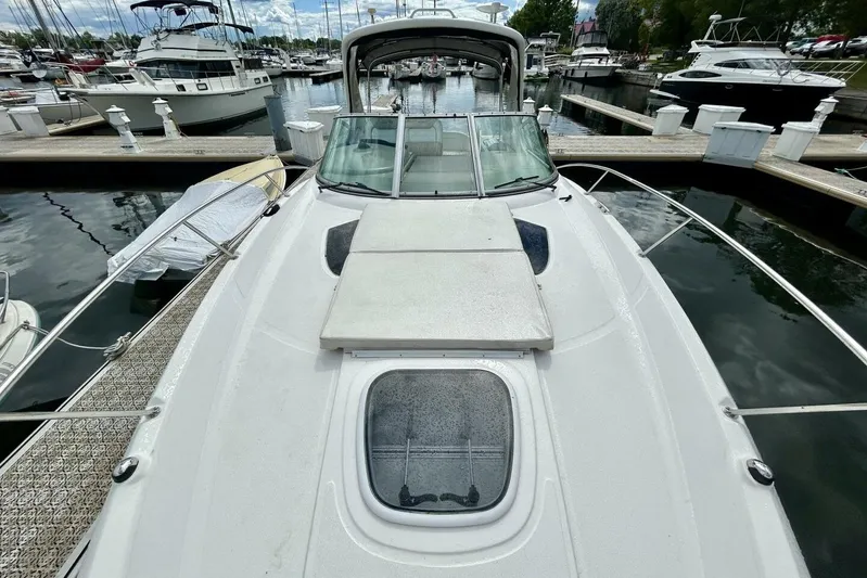  Yacht Photos Pics 2009 Sea Ray 310 Sundancer docked at marina, showcasing sleek design and spacious deck.