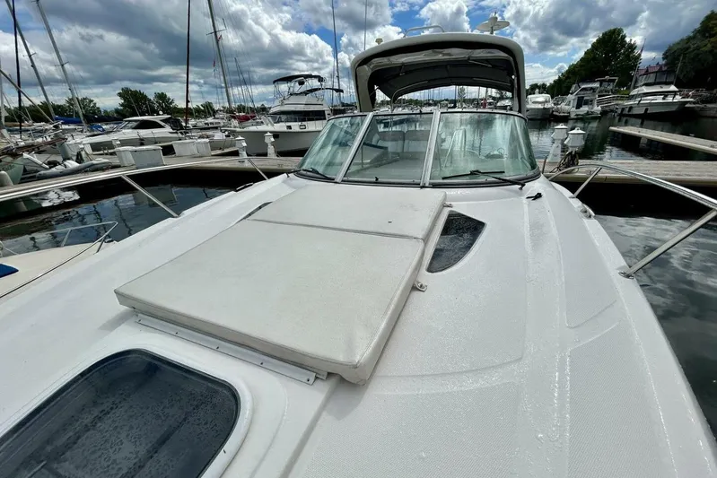  Yacht Photos Pics 2009 Sea Ray 310 Sundancer docked at marina under cloudy sky.