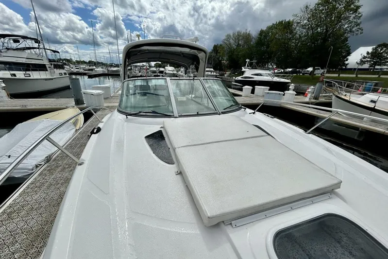  Yacht Photos Pics 2009 Sea Ray 310 Sundancer docked at marina under cloudy sky.