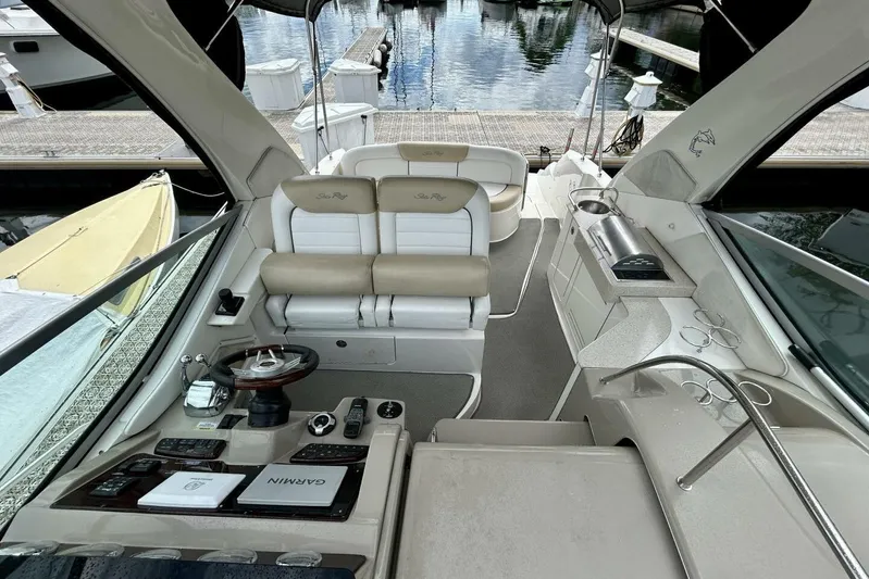  Yacht Photos Pics 2009 Sea Ray 310 Sundancer cockpit with helm, seating, and marina view.