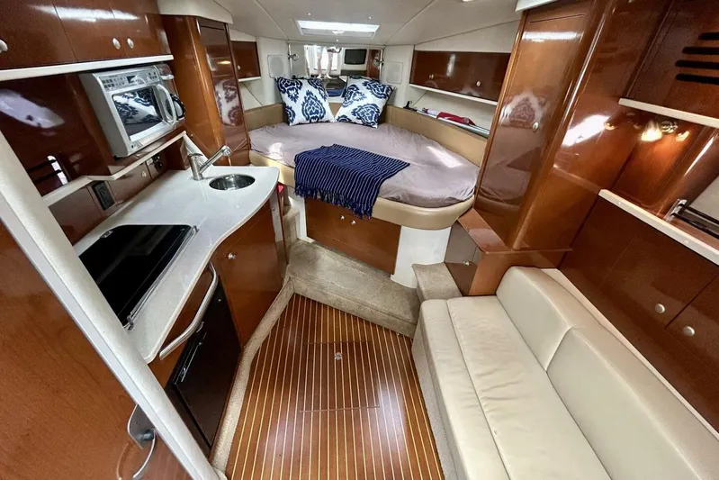  Yacht Photos Pics Luxurious interior of 2009 Sea Ray 310 Sundancer yacht with kitchenette and cozy sleeping area.