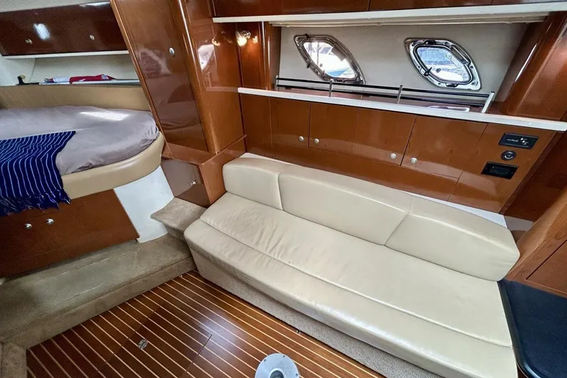  Yacht Photos Pics Luxurious interior of 2009 Sea Ray 310 Sundancer with beige seating and wood accents.