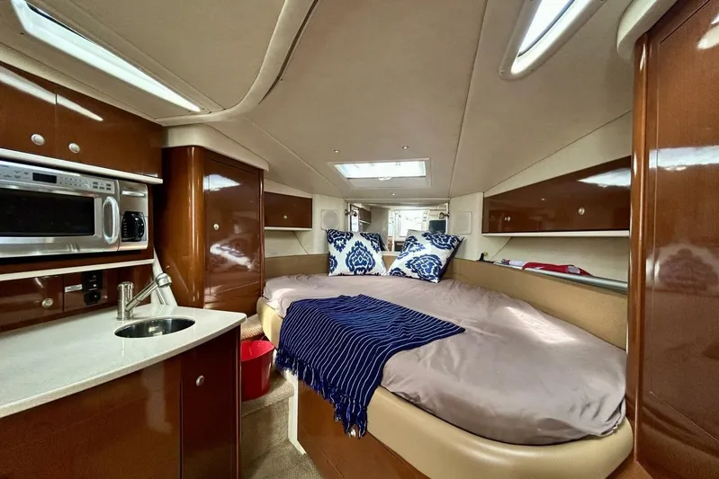  Yacht Photos Pics 2009 Sea Ray 310 Sundancer cabin interior with bed, kitchenette, and modern amenities.