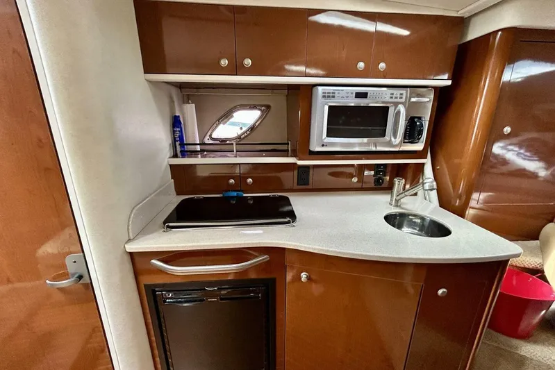  Yacht Photos Pics 2009 Sea Ray 310 Sundancer galley with microwave, sink, and compact fridge.
