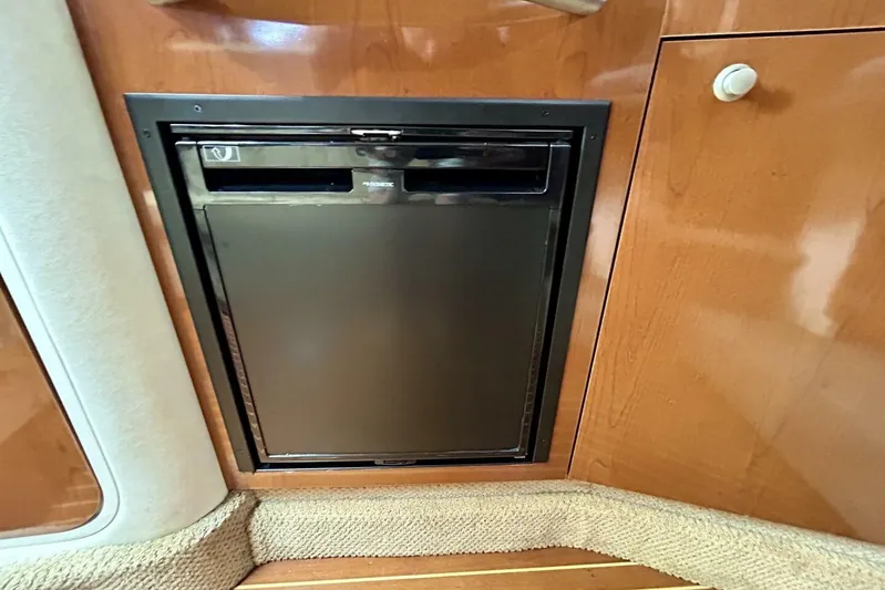  Yacht Photos Pics Built-in refrigerator on 2009 Sea Ray 310 Sundancer yacht, wooden interior.