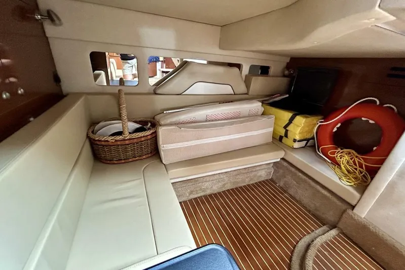 Yacht Photos Pics Interior cabin of 2009 Sea Ray 310 Sundancer with seating, basket, and life preserver.