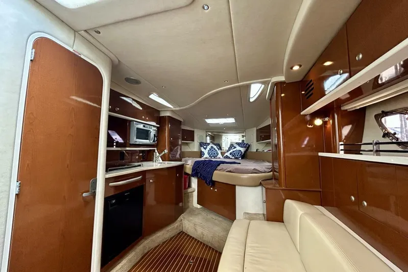  Yacht Photos Pics 2009 Sea Ray 310 Sundancer interior with kitchen, seating, and cozy sleeping area.