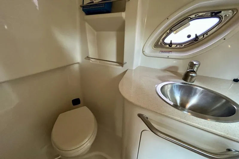  Yacht Photos Pics 2009 Sea Ray 310 Sundancer bathroom with stainless steel sink and porthole window.